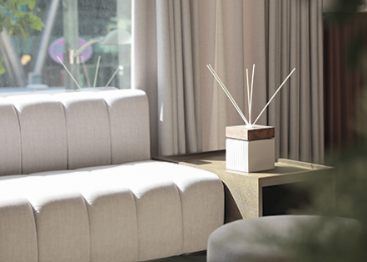 Waiting area sofa by the window at BBAE Clinic