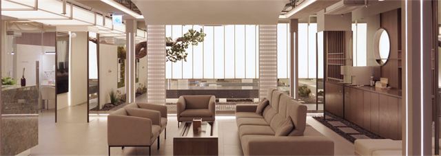 4th-floor lounge of Kleam Skin Clinic Myeongdong with sofas and an indoor pine tree