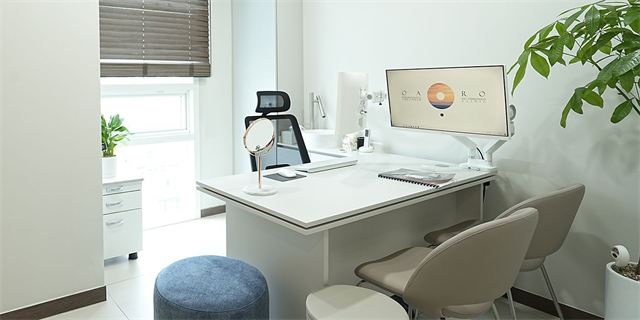 Consultation room with a desk, monitor and mirror at Oaro Skin Clinic Cheongdam