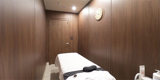 Care room with a bed and wood-panelled walls at Oaro Skin Clinic Cheongdam