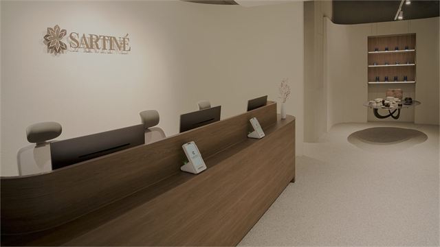Reception desk and SARTINÉ logo wall of Sartine Skin Clinic