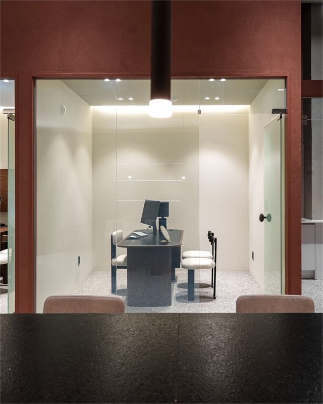 Glass-walled consultation room at Sartine Skin Clinic