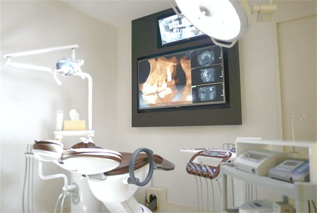Dental chair with a wall monitor showing CT images at Yonsei Heal Dental Hospital