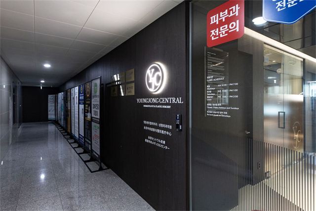 조양타워 3층 영종센트럴피부과의원 입구의 YJC 로고 조명, 병원명 표기와 진료시간 안내판